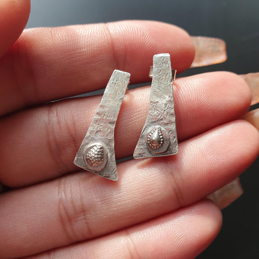 Asymmetrical,textured design,triangular,studs,silver,hammered,Teardrop accent.